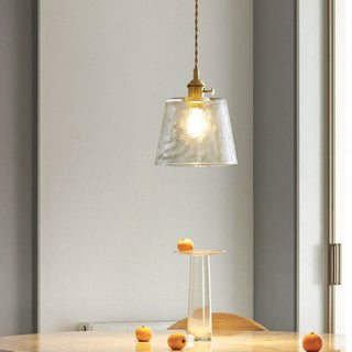 Modern glass cup pendant casting soft upward glow