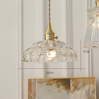 Clear glass pendant casting undistorted warm glow