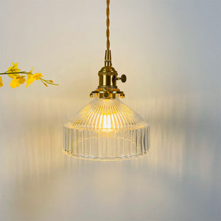 Vintage brass glass pendant casting warm ambient glow