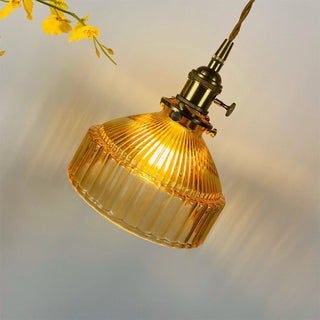 Retro glass pendant with brass accents over dining table