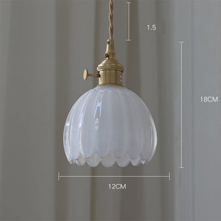 Clear glass flower pendant casting delicate petal shadows