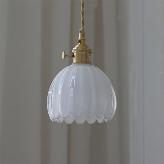 Mid-century pendant with glass flower shade over dining table