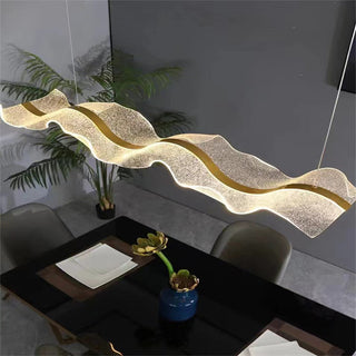 Ripple-pattern glass pendant over contemporary dining room