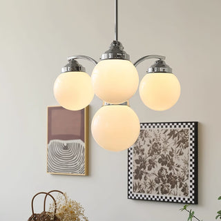 Retro round glass chandelier chrome finish hanging over dining room