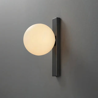 White ball wall light side angle — minimalist spherical fixture