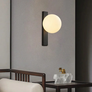 White ball wall light in interior — minimalist spherical lamp