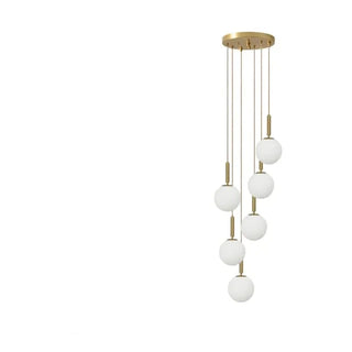 Brass pendant light with frosted globe shade — designer ceiling lamp
