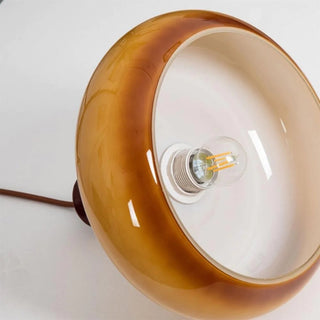 Yellow retro pendant with dome shade over kitchen island