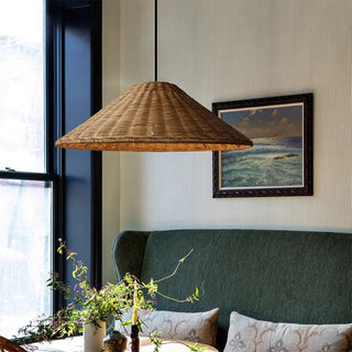 Adjustable rattan cone pendant over dining table