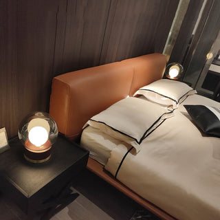 Round metal wood glass lamp detail — contemporary warm
