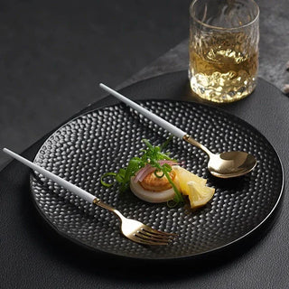ceramic plate earthworks handcrafted porcelain elegant black white textured dishware close-up