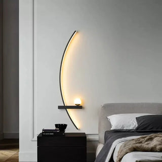 Colomba wall sconce illuminated — sleek curved black aluminum light