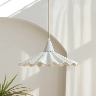 Christie pendant lamp illuminated — warm glow through ceramic wave shade
