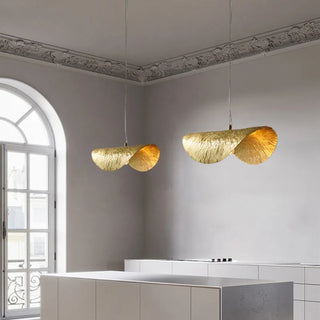 Leaf-shaped copper pendant lamp illuminated — warm amber glow