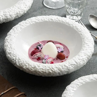 ceramic plate collection earthworks handcrafted porcelain dinnerware textured edges close-up