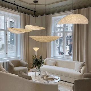 Modern white pendant lamp hanging in contemporary interior