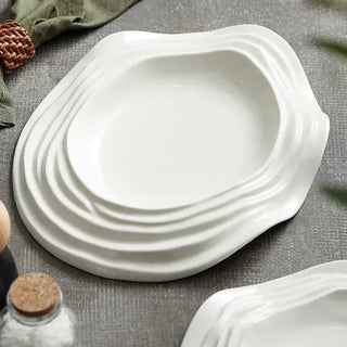 white ceramic plate earthworks handcrafted porcelain plates unique wave design close-up