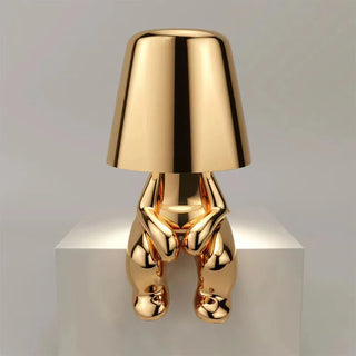 Golden resin table lamp close-up — designer warm detail