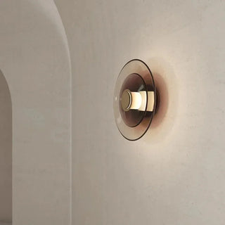 Walnut stained glass disc wall lamp illuminated — Gino fixture