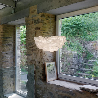 Steel mesh pendant light illuminated — warm LED glow through woven metal