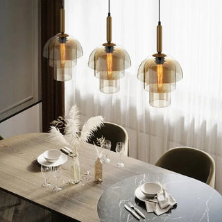 Salt pendant over dining table — cognac glass and brass hanging light