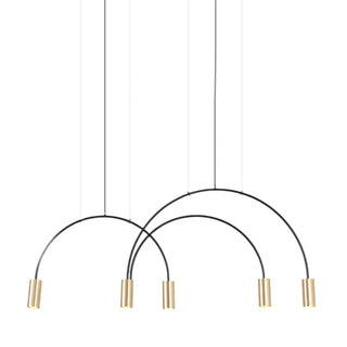 Arca pendant light illuminated — warm brass glow in modern interior