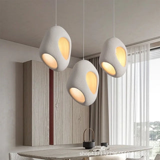 Kerrá Kos pendant illuminated — warm glow through handcrafted resin