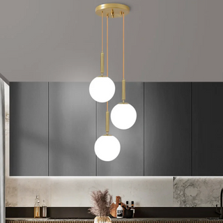 Modern brass and frosted glass ball pendant hanging in a contemporary living room