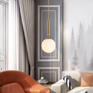 Frosted glass globe pendant with adjustable brass cord — luxury lighting fixture