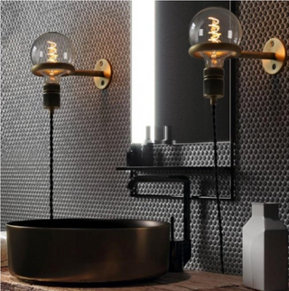 Industrial wall lamp illuminated — warm E27 bulb metal fixture