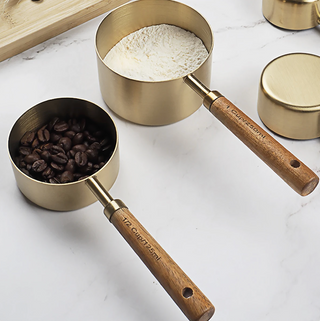 gold measuring cups 8 piece stainless steel wood accent handles close-up