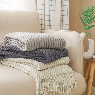 hand-knitted blanket cozy throw soft polyester malibu texture close-up