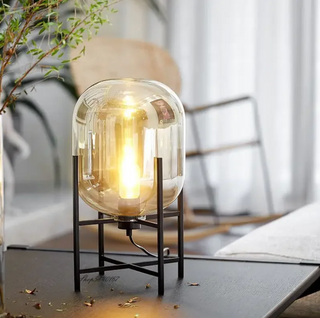 Hand blown amber glass lamp front — black steel frame