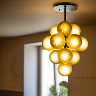 Grape-shaped aubergine glass pendant close-up — luxury hanging lamp