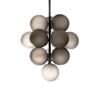 Smoky grey hand-blown glass pendant lamp hanging over a dining table