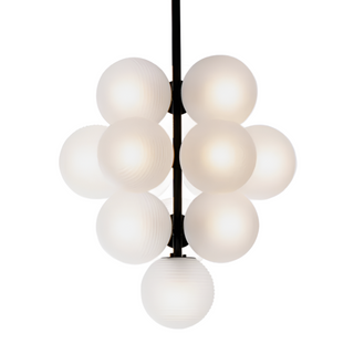 Artisan hand-blown glass pendant lamp over dining area — amber toned