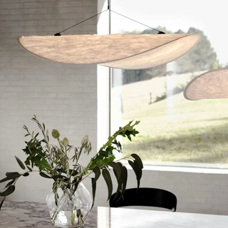 Adjustable white pendant lamp close-up — LED bulb ceiling fixture