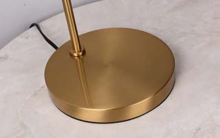 Designer sphere lamp brass arc — warm ambient living room setting