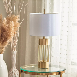 Golden vault table lamp illuminated — luxury warm glow