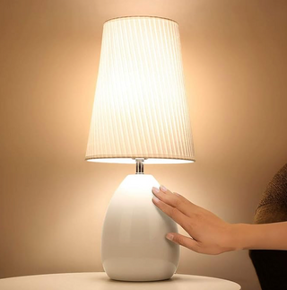 Touch dimming monochrome lamp illuminated — warm ambient glow