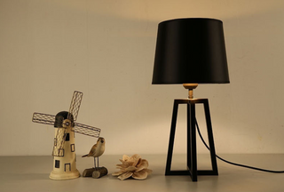 Designer black shade lamp close-up — sleek modern detail