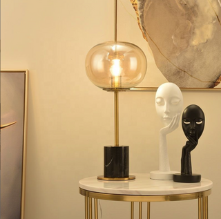 Marble sphere lamp front — glass globe golden stem modern light