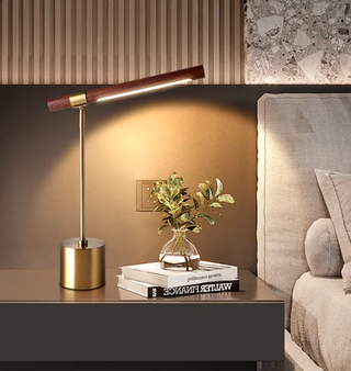 Brass base lamp dark shade illuminated — minimalist warm glow