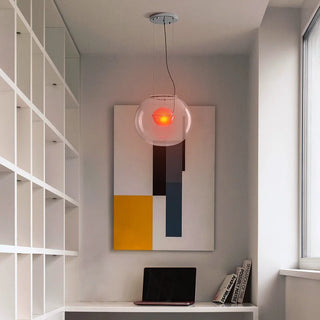Red glass sphere pendant hanging in an elegant interior — luxury pendant lamp