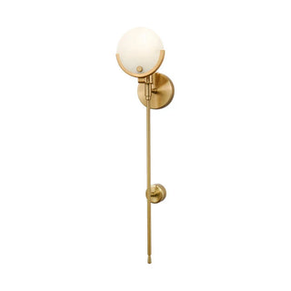 Spanish marble and brass wall sconce illuminated — luxury lamp
