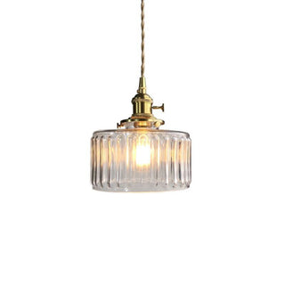 Vintage cylindrical glass pendant over kitchen island