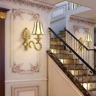 Gold metal mid-century wall sconce — warm ambient light fixture