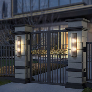 Contemporary minimalist outdoor sconce on exterior — warm LED lamp