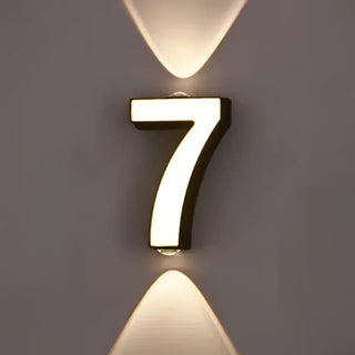 Number lit LED sconce close-up – white digit warm glow accent