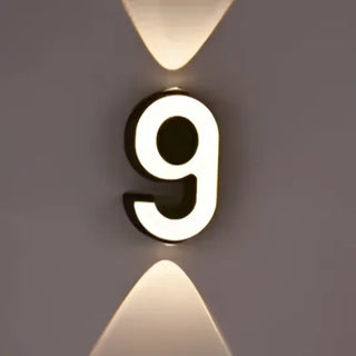 LED number wall light installed – black white bold typographic statement